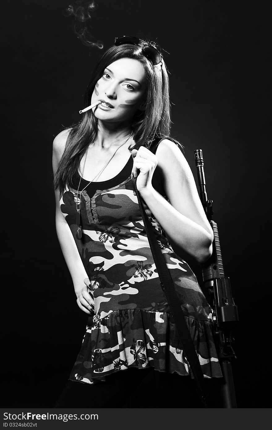 Attractive and sexy spy woman with assault rifle