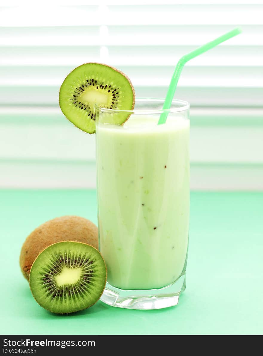 Kiwi juice in a glass on a light background