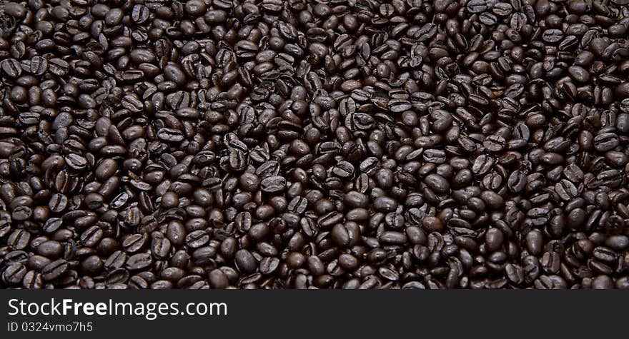 Whole roasted organic coffee beans, evenly displayed as a background.