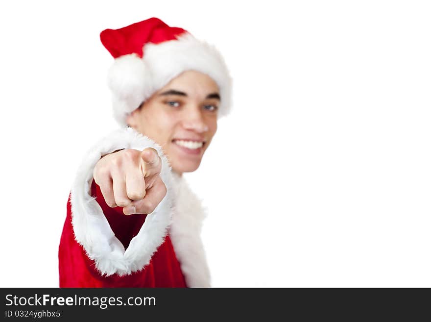 Smiling male teenager dressed as santa claus points with finger. Isolated on white background.