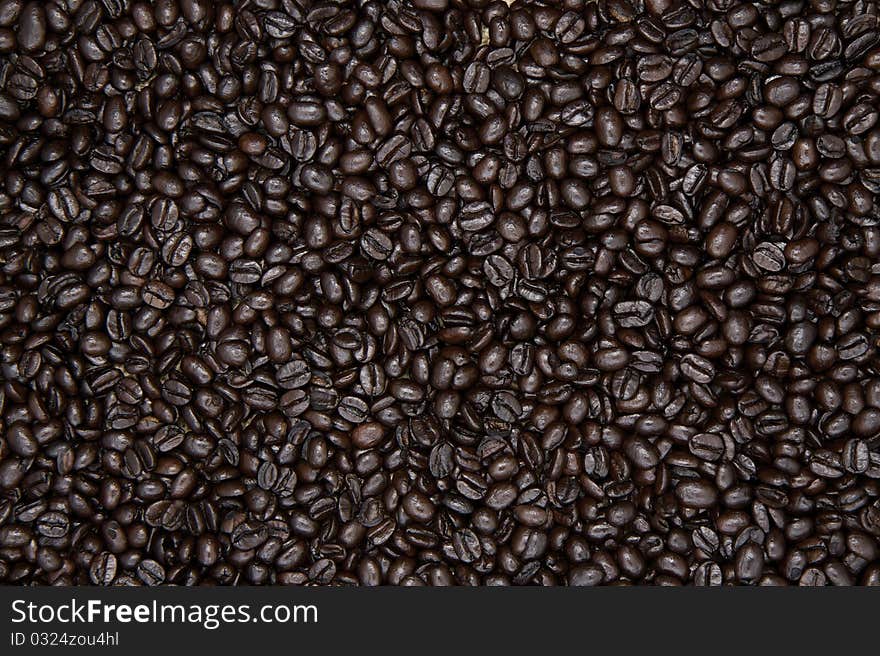 Whole roasted organic coffee beans, evenly displayed as a background.