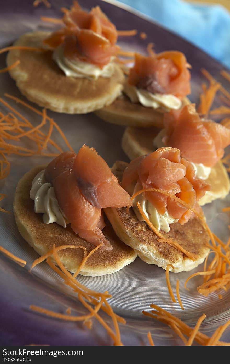 Salmon crepe and carrot on plate