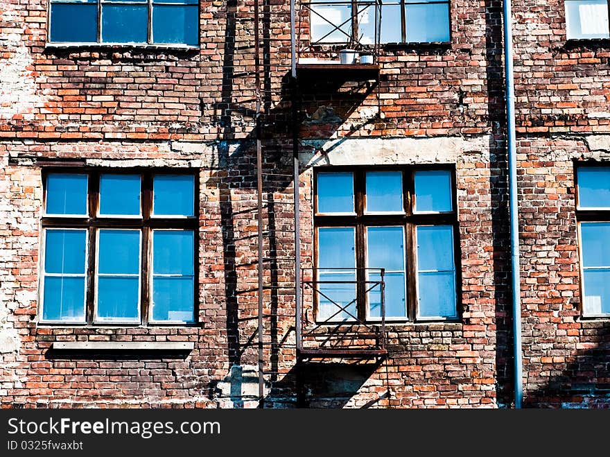 Houses of stone wall with many blue windows