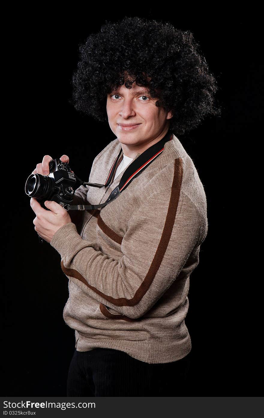 Funny guy with a camera on a black background