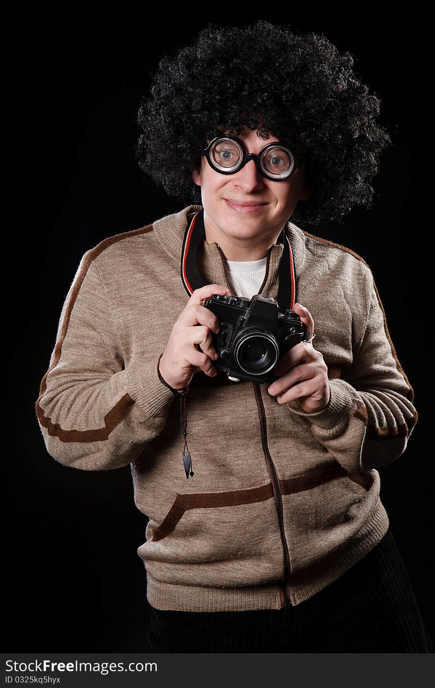 Funny guy with a camera on a black background