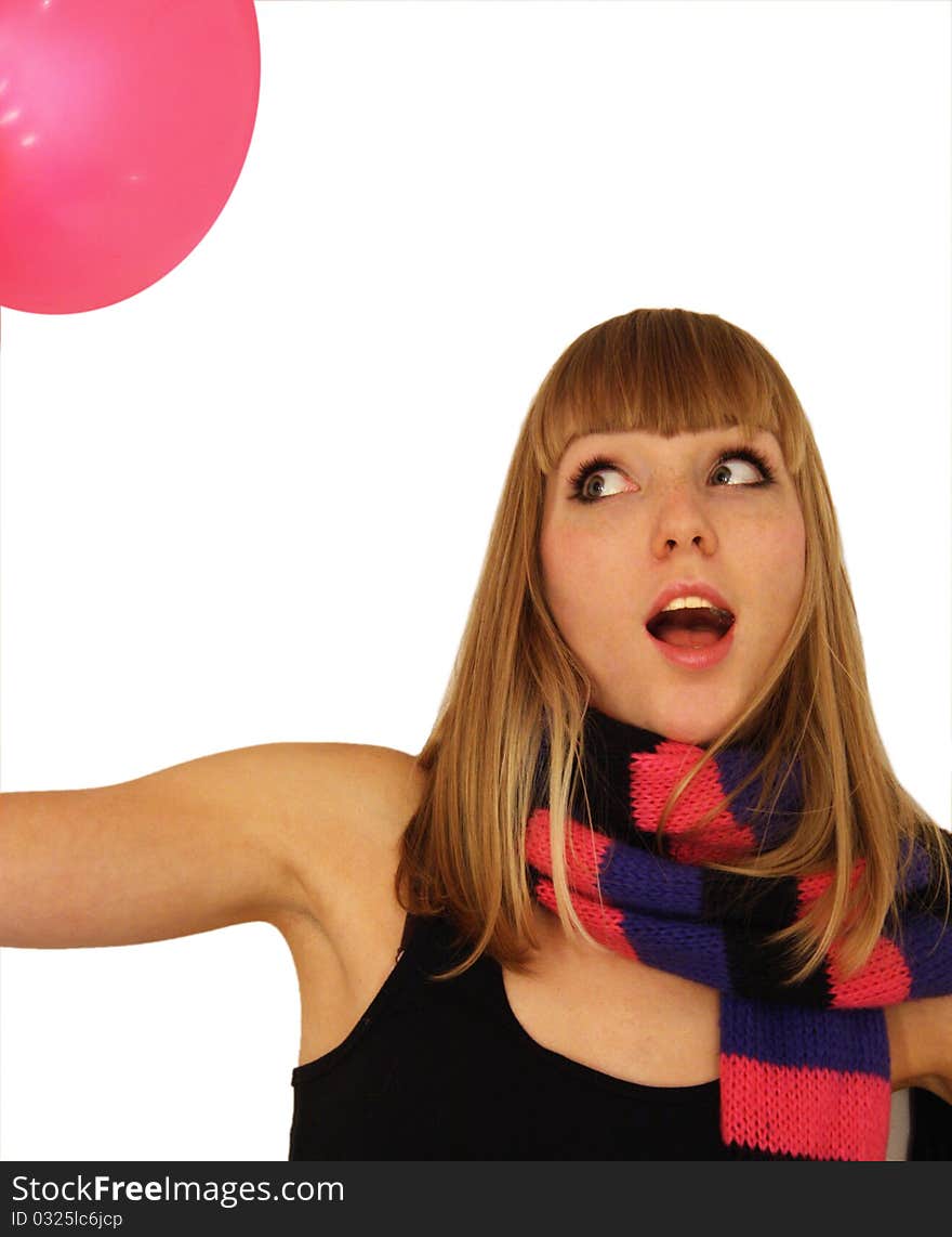 Beautiful blond girl in a pink scarf with black stripes plays with a pink balloon. Beautiful blond girl in a pink scarf with black stripes plays with a pink balloon