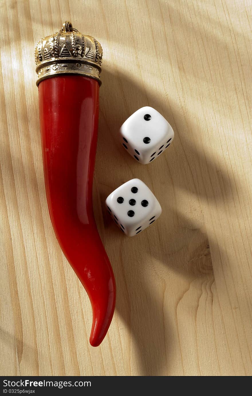 A red horn and two dice. A red horn and two dice