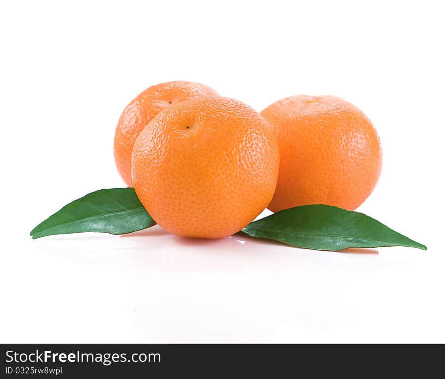 Mandarins isolated and green leaves on white