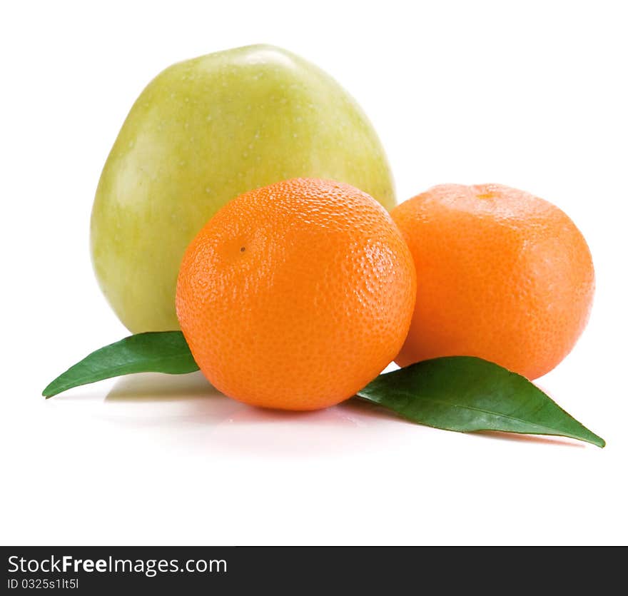 Mandarins and apple isolated and green leaves on white background. Mandarins and apple isolated and green leaves on white background