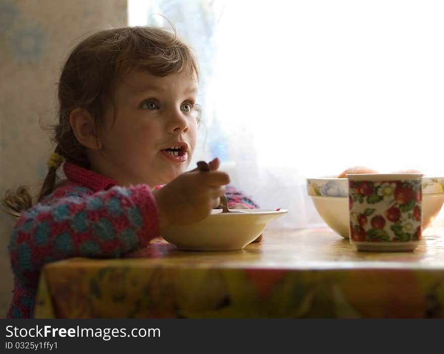 Garden house. Funny little girl for lunch