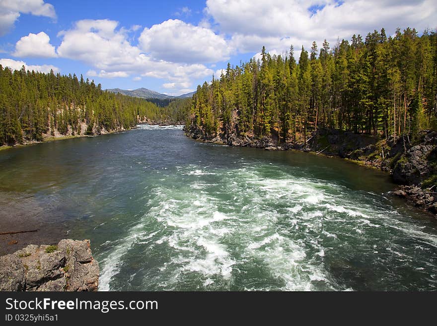 Yellowstone River in Yellowstone National Park with blue sky and clouds