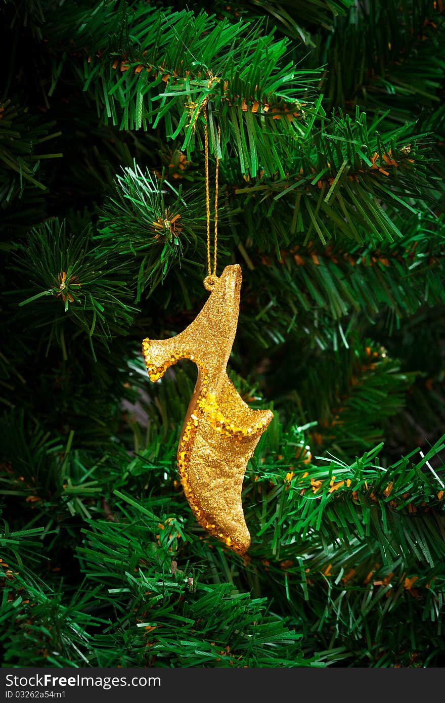 Gold shoe on the artificial Christmas tree