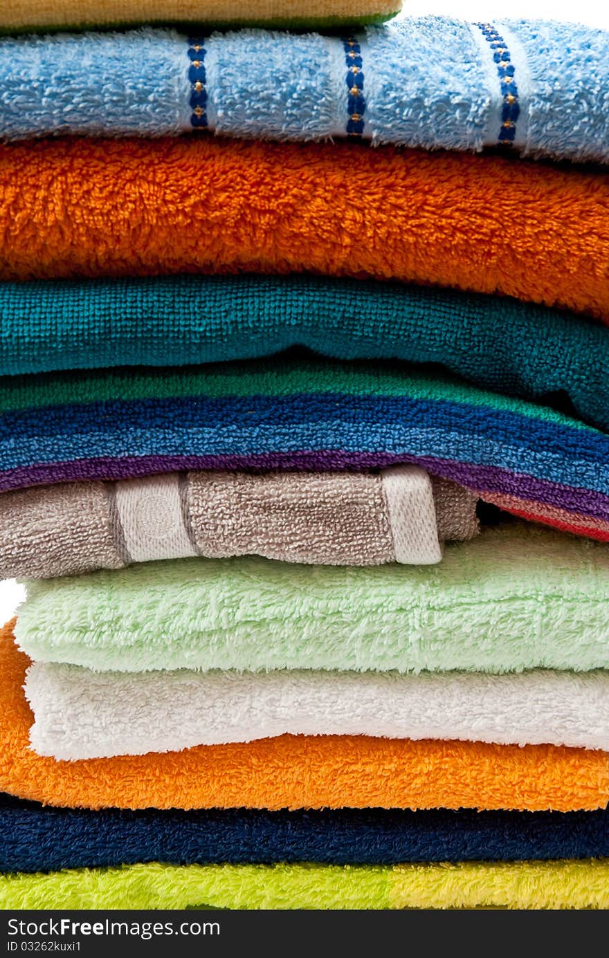 Pile of bright color towels isolated on withe background. Pile of bright color towels isolated on withe background