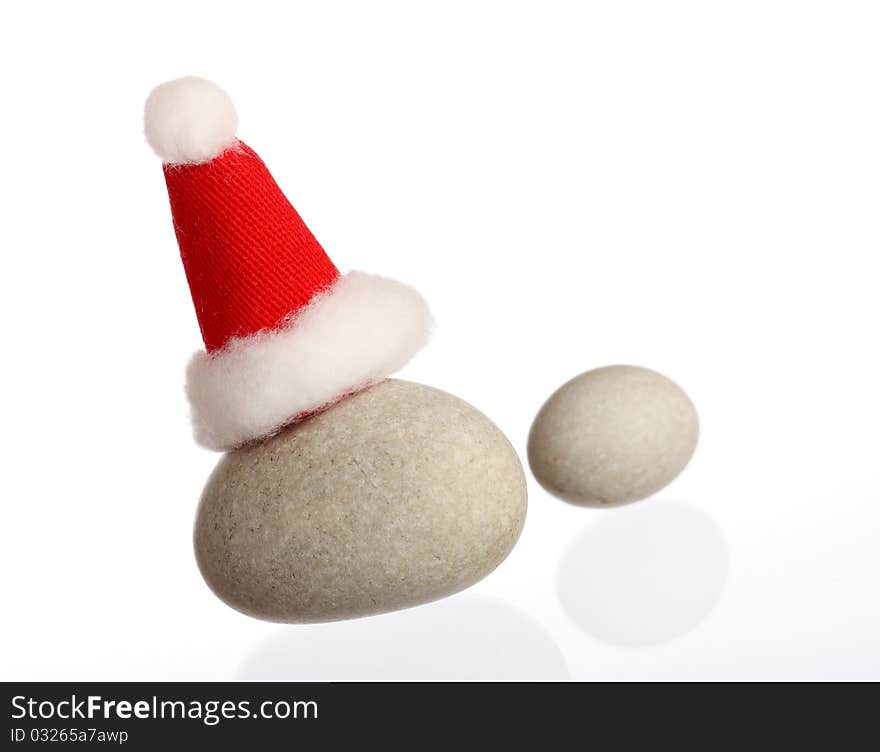 New Year: two small stones with Santas cap