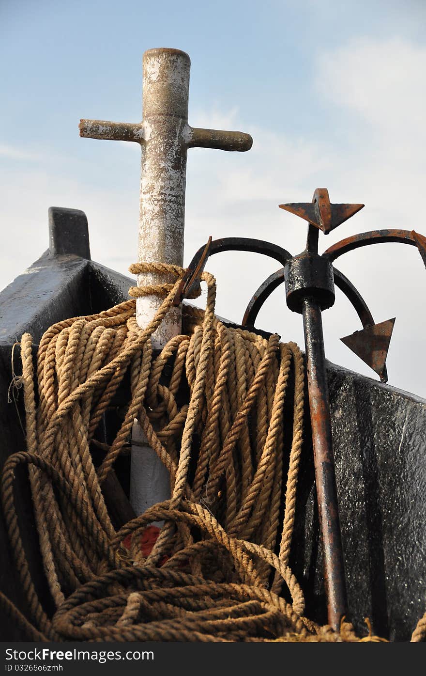 Closeup of a ships anchor covered with rope in the bow of a boat on the shores of Goa India. Closeup of a ships anchor covered with rope in the bow of a boat on the shores of Goa India