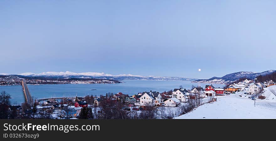 Moon over Finsnes. A typical Norwegian winter landscape. Moon, a bridge, the polar night.