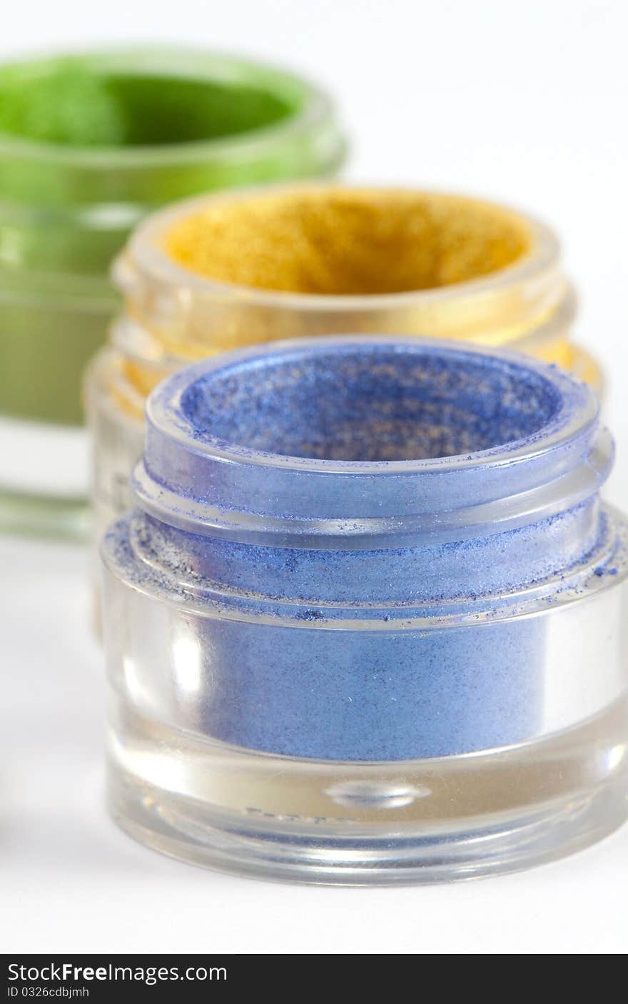 Colorful eye shadow jars on white background. Colorful eye shadow jars on white background.