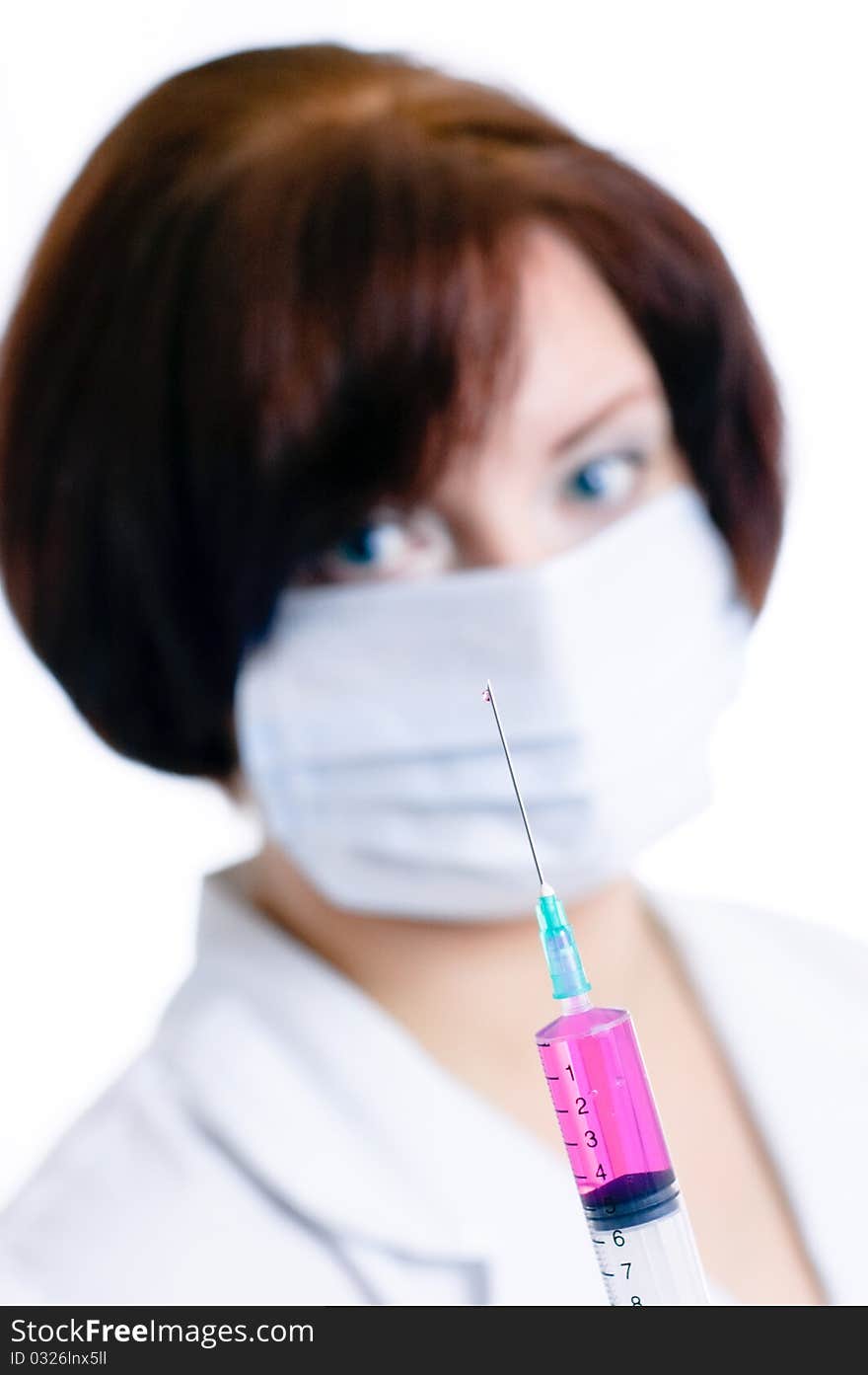 Doctor with a syringe isolated on white