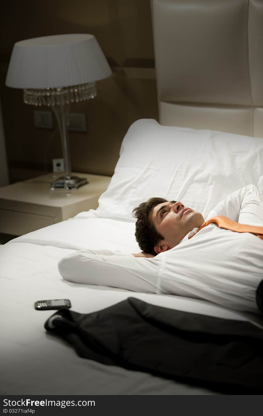 Tired Businessman resting in hotel room. Tired Businessman resting in hotel room