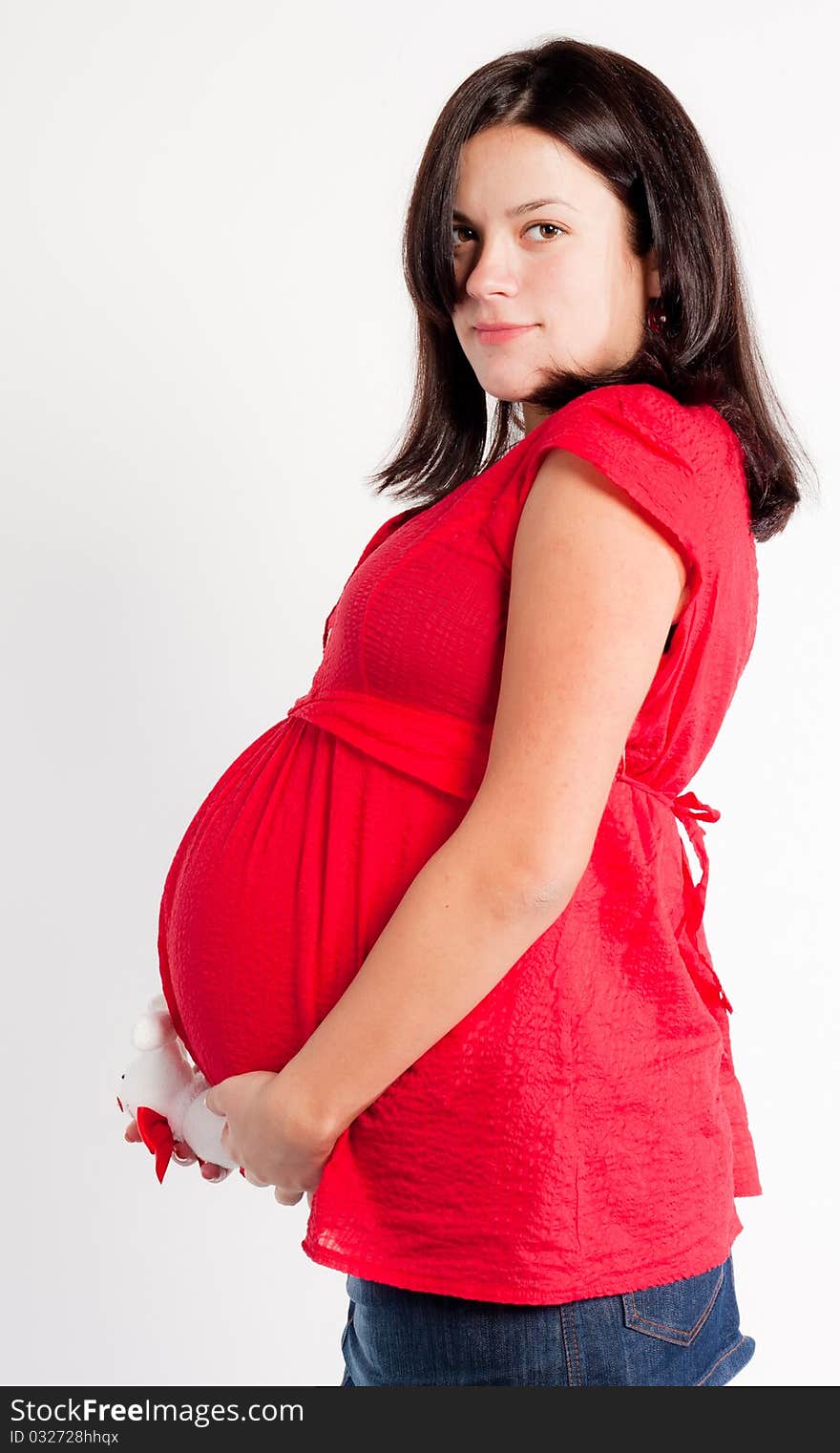 Beautiful pregnant woman staing on light grey background