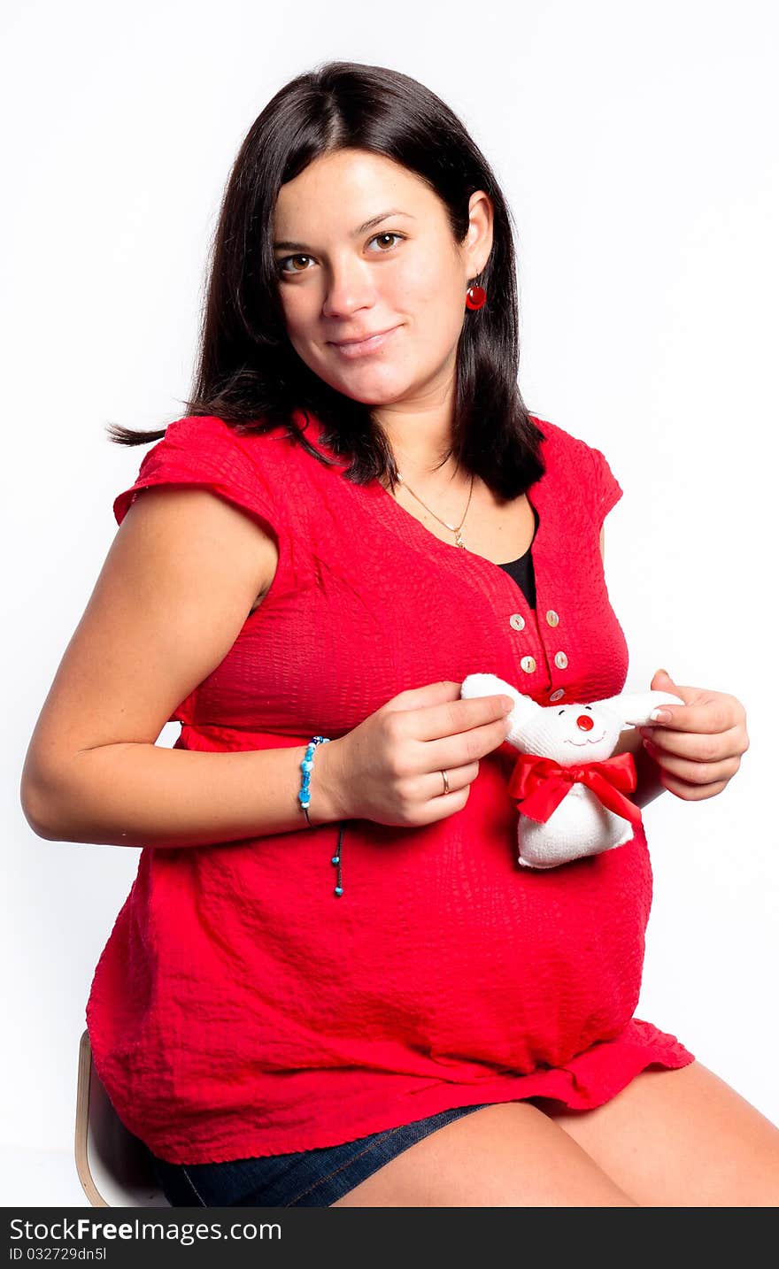 Beautiful pregnant woman staing on light grey background