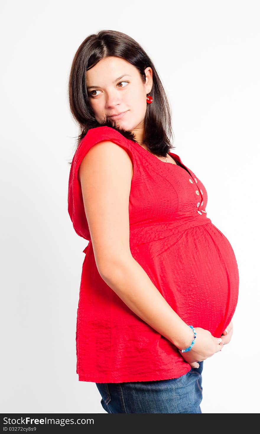 Beautiful pregnant woman staing on light grey background