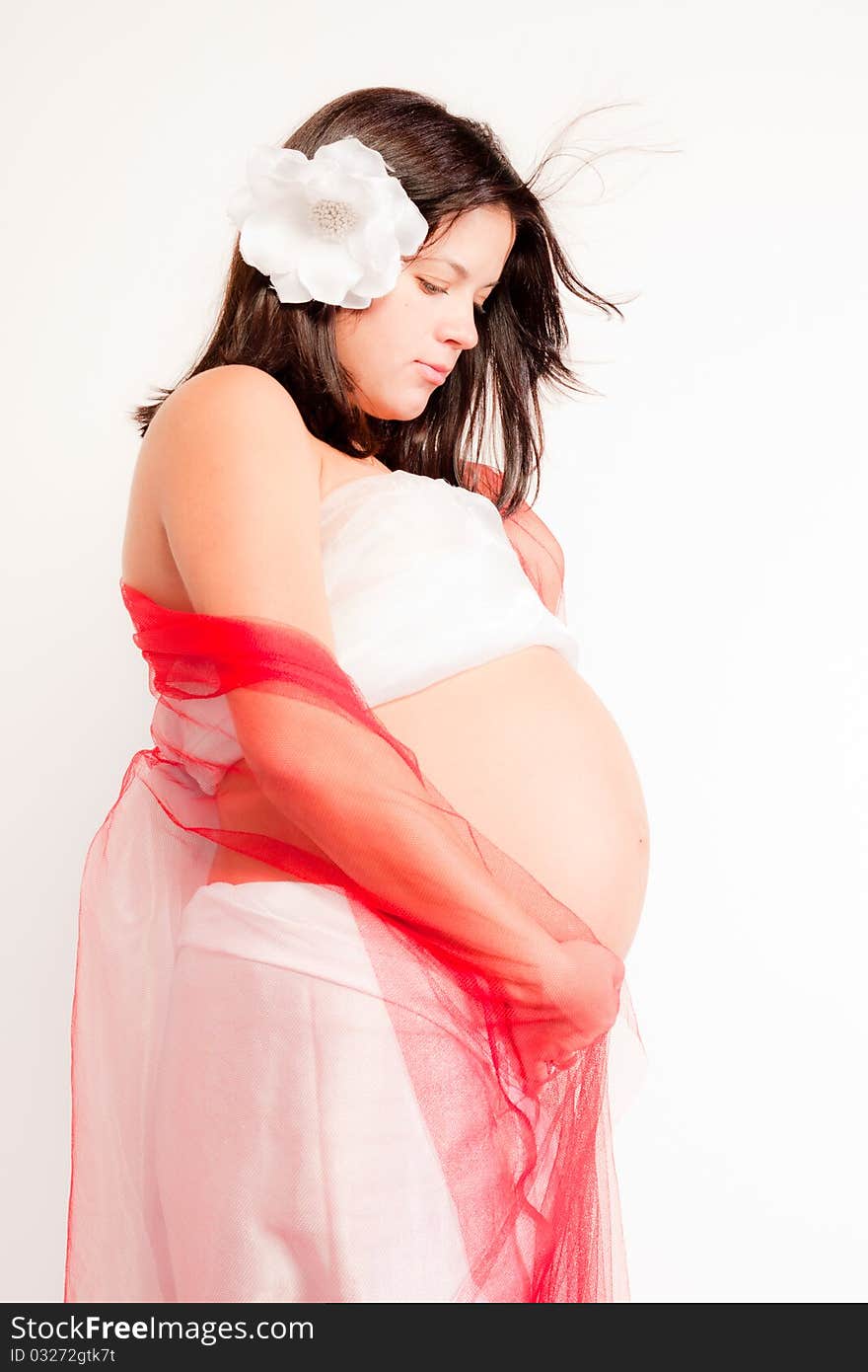 Beautiful pregnant woman staing on light grey background, close up