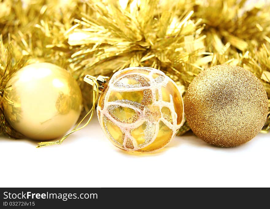 New Year's ornament gold full-spheres lie on a gold background. New Year's ornament gold full-spheres lie on a gold background