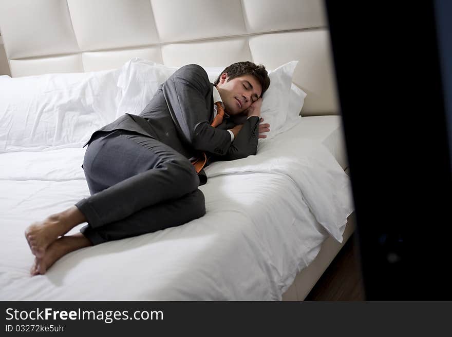 Businessman Asleep In Hotel Bedroom. Businessman Asleep In Hotel Bedroom