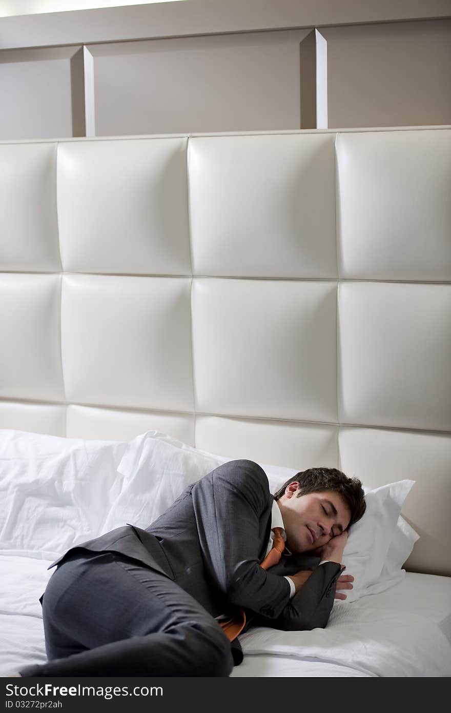 Businessman Asleep In Hotel Bedroom. Businessman Asleep In Hotel Bedroom