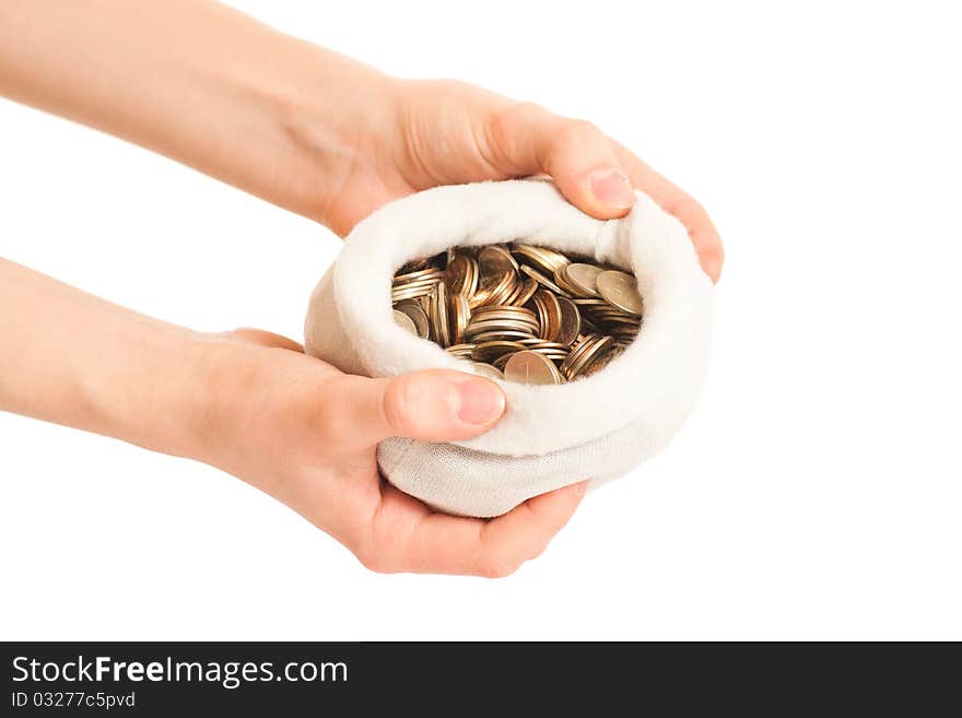 Hand holds bag with coins on white