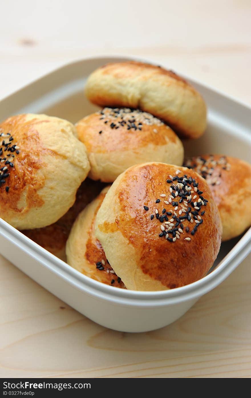 Close up of bread bun in container on table.