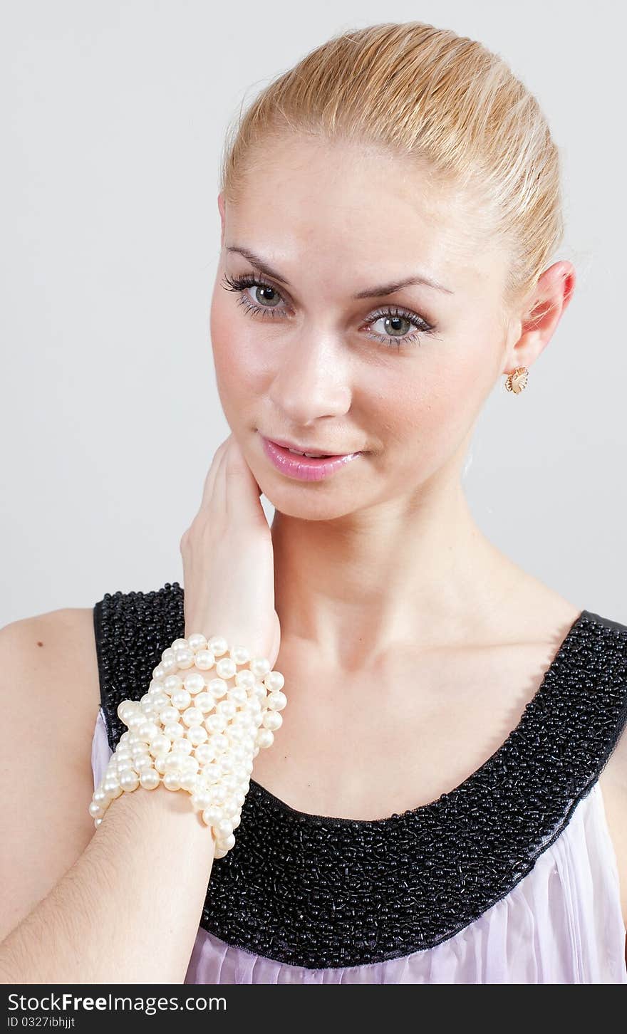 Lovely blonde female with pearl bracelet