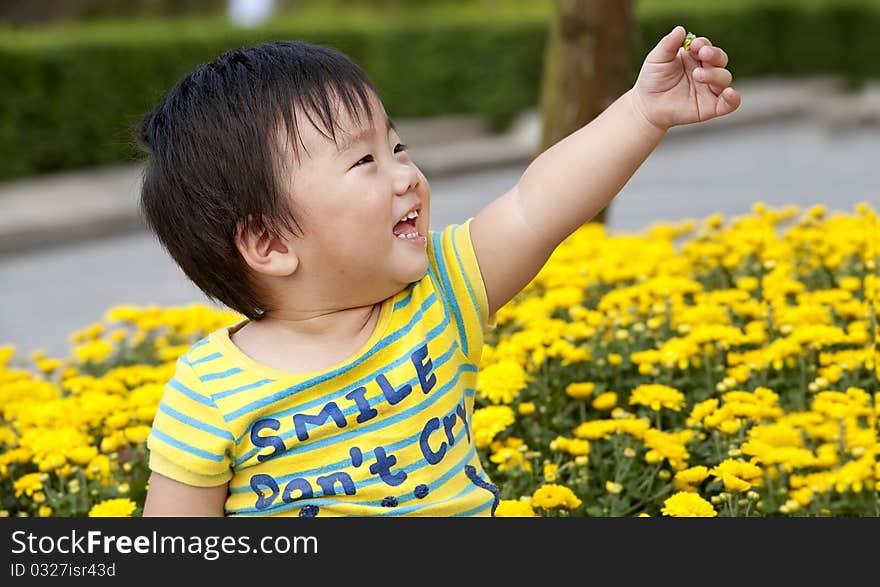 Happy baby is playing in a garden