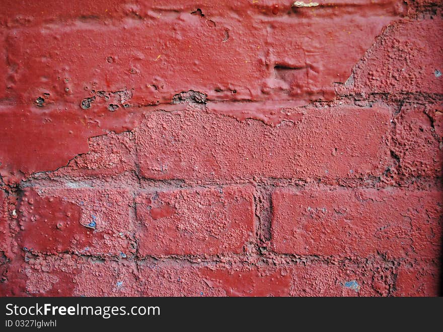 A brick wall painted red. A brick wall painted red