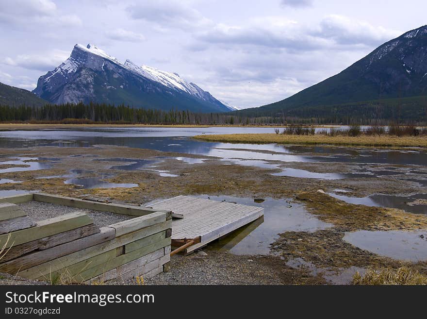 A boating Dock Located on a Shallow Mountain Lake. A boating Dock Located on a Shallow Mountain Lake