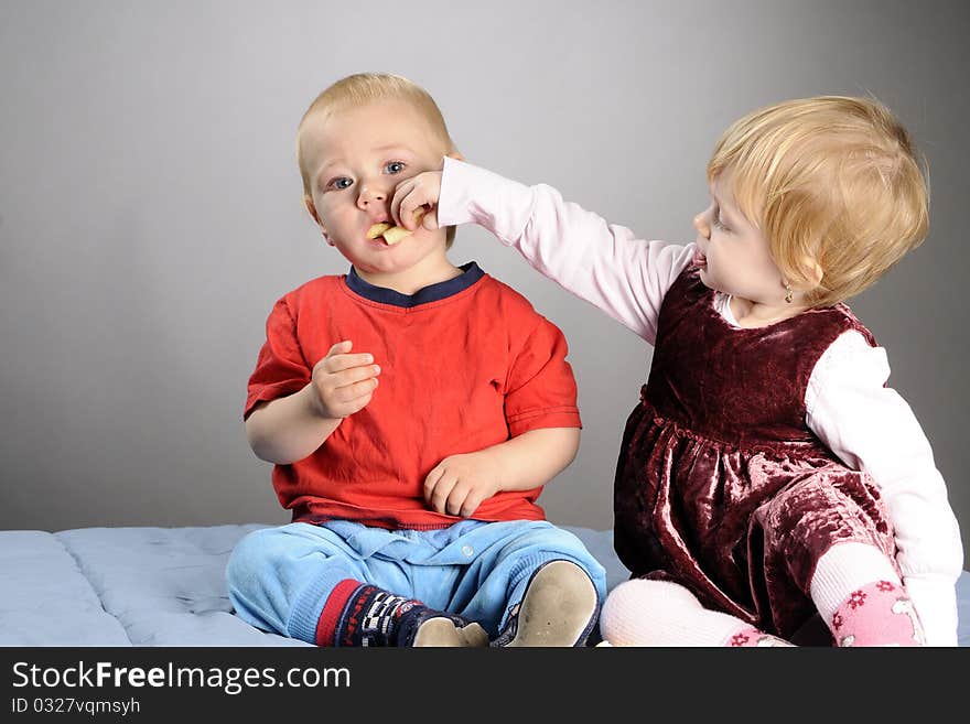 White baby girl preparing to offer food to her little friend. White baby girl preparing to offer food to her little friend