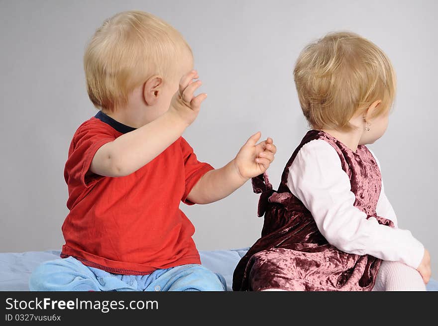 Beautiful baby boy and girl having fun with ball. Beautiful baby boy and girl having fun with ball