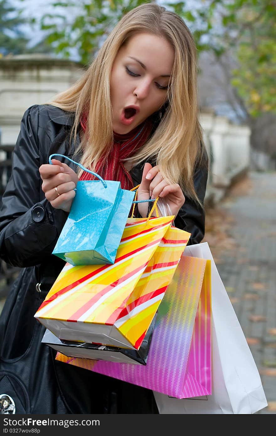 Autumn shopping. Fashion woman with bags. Autumn shopping. Fashion woman with bags