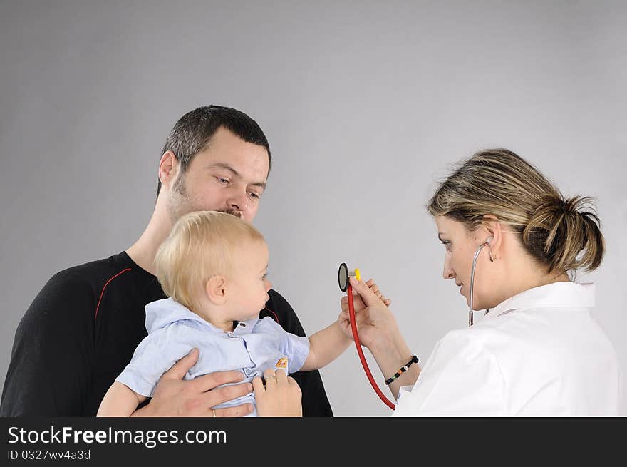 Young doctor preparing to make examination with stethoscope to baby boy. Young doctor preparing to make examination with stethoscope to baby boy