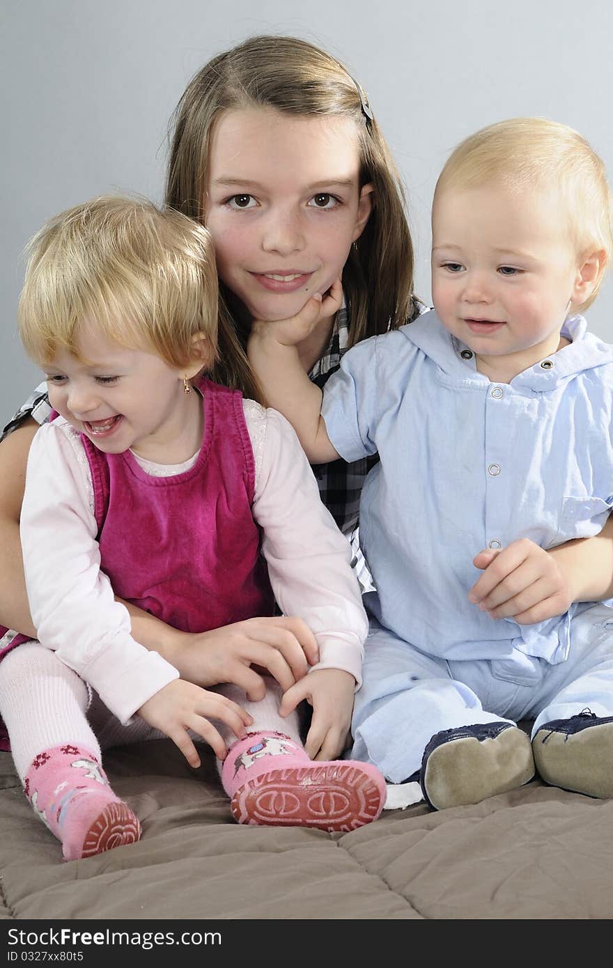 Two beautiful white babies and girl posing together. Two beautiful white babies and girl posing together