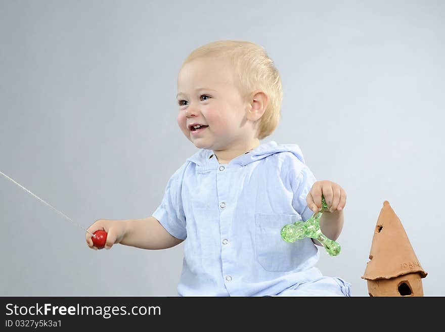 Beautiful baby boy having fun with toys. Beautiful baby boy having fun with toys