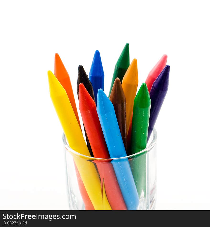 Color pencils stand in a transparent glass. Color pencils stand in a transparent glass