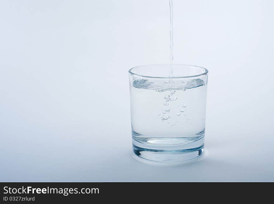 Water In A Glass On A Blue Background