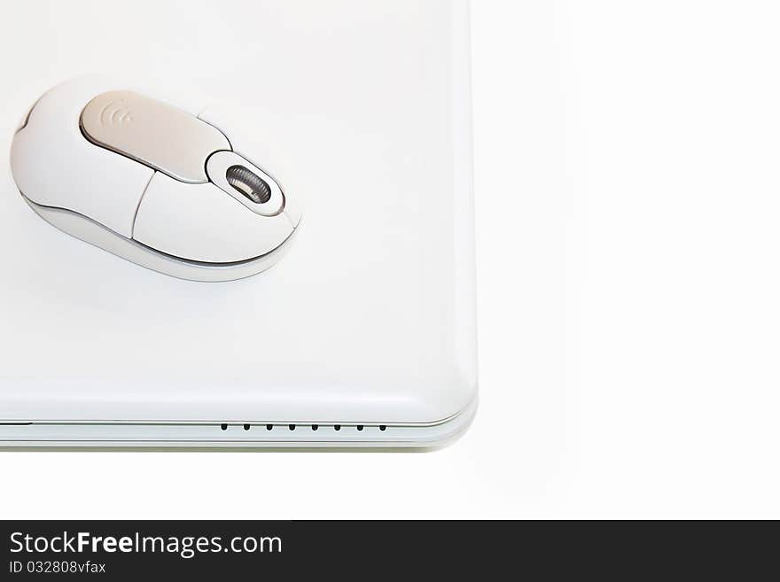 White laptop with cordless mouse