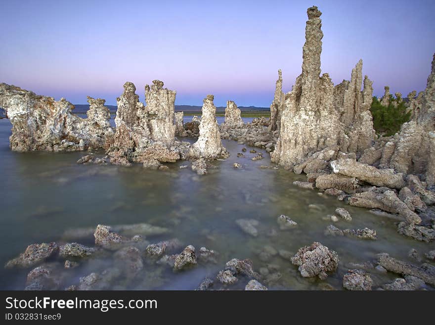 Ancient formations of tufa rocks at Mono Lake in California. The landscape looks like it is on the moon, and the environment is relatively harsh.