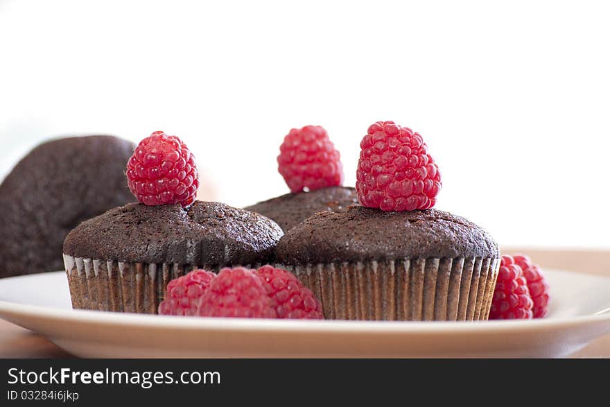 Brown muffins with raspberry close up