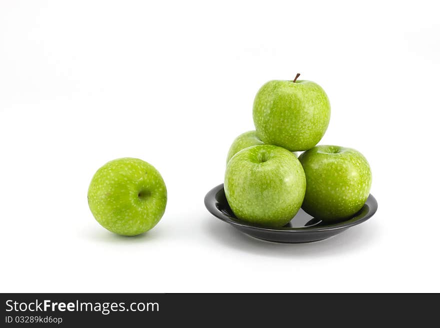 Fresh green apple on plate isolated on white background. Fresh green apple on plate isolated on white background