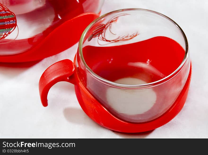 A red handle and a glass coffee cup coffee pot locally. A red handle and a glass coffee cup coffee pot locally