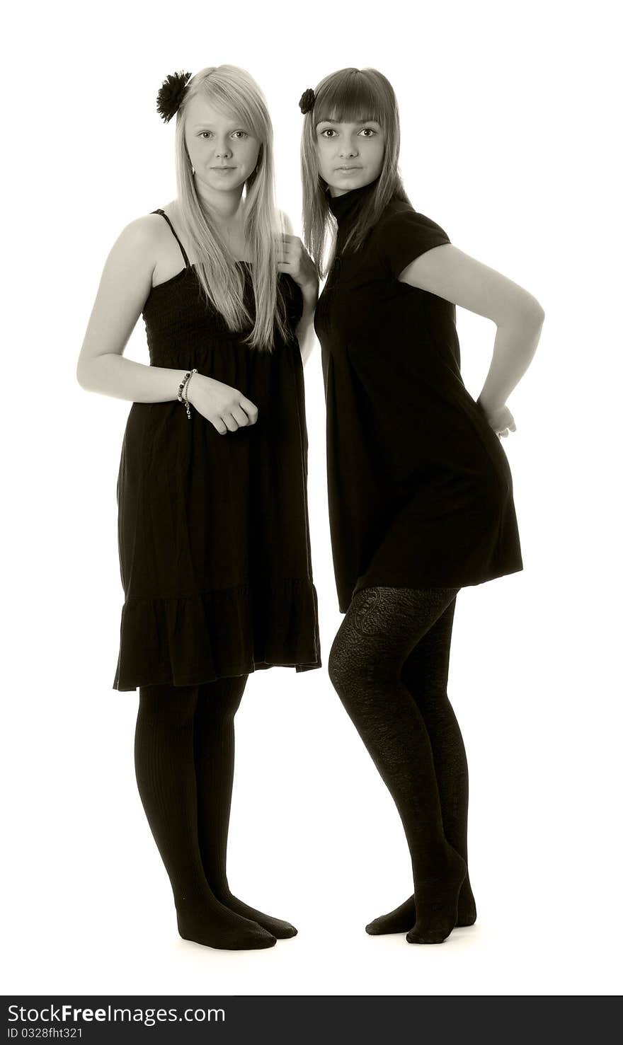 Two girls in black dresses with a white background (black and white). Two girls in black dresses with a white background (black and white)